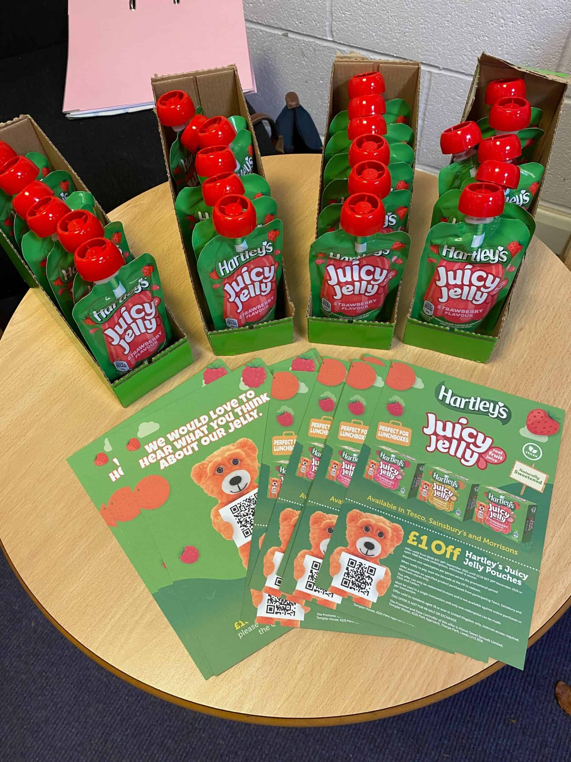 Hartley's Juicy Jelly fruit flavour samples with red bottles on a table.