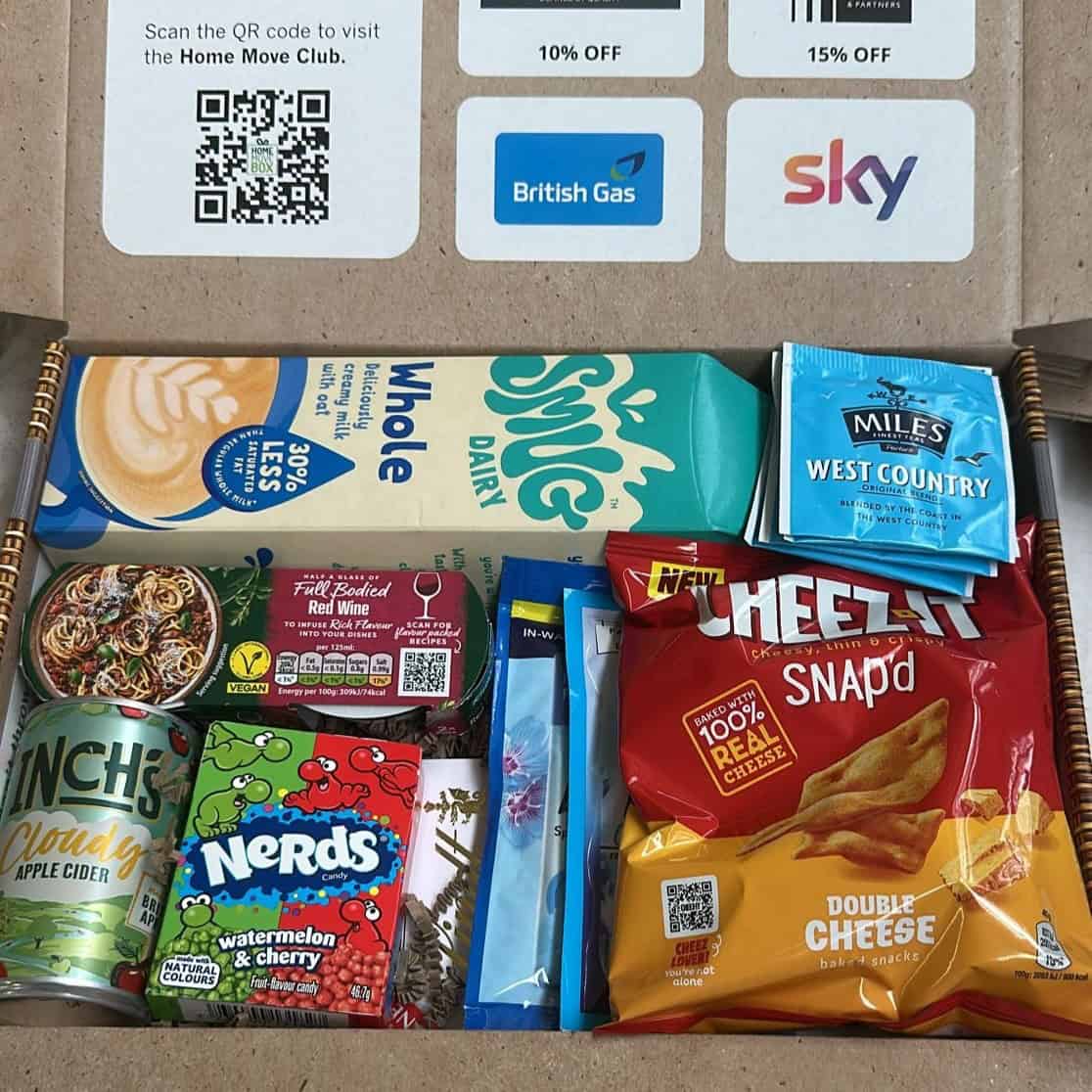 Assorted snacks including cheese, chips, and drinks in a box.