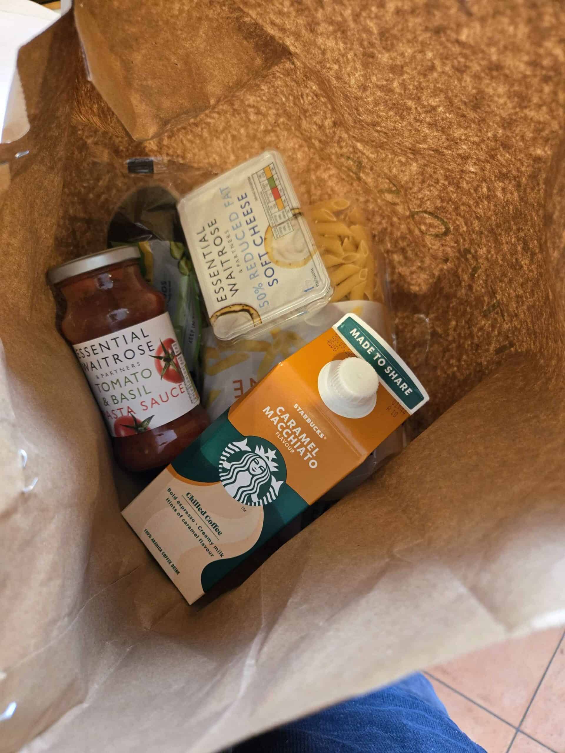 Tomato basil pasta sauce, cheese, and caramel macchiato in paper bag for flavour sampling.